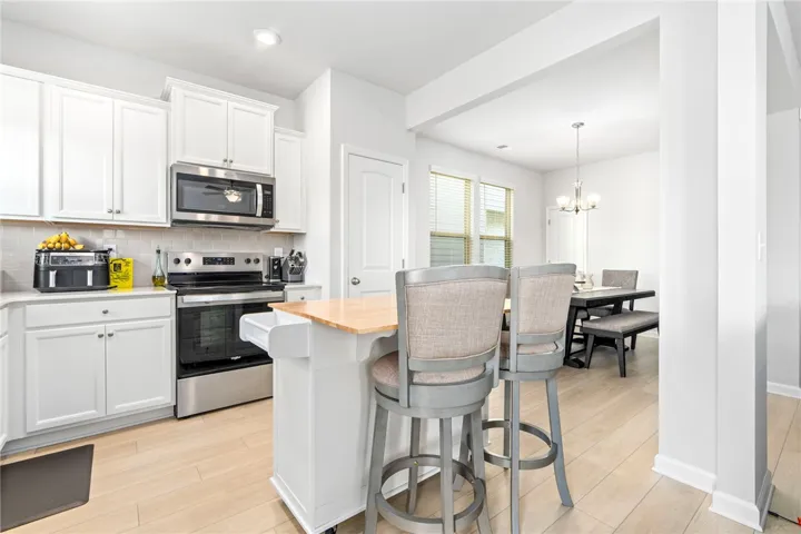 Clean lines and a spacious kitchen island anchor this bright, open culinary space.