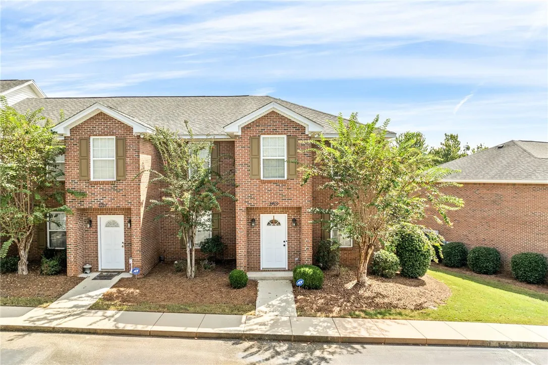 Classic brick architecture defines this multi-family exterior with private entryways and neat concrete walkways.