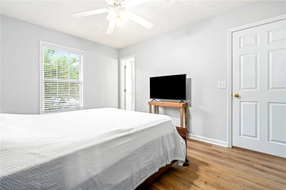 Gleaming wood floors run throughout this inviting space featuring a large window.