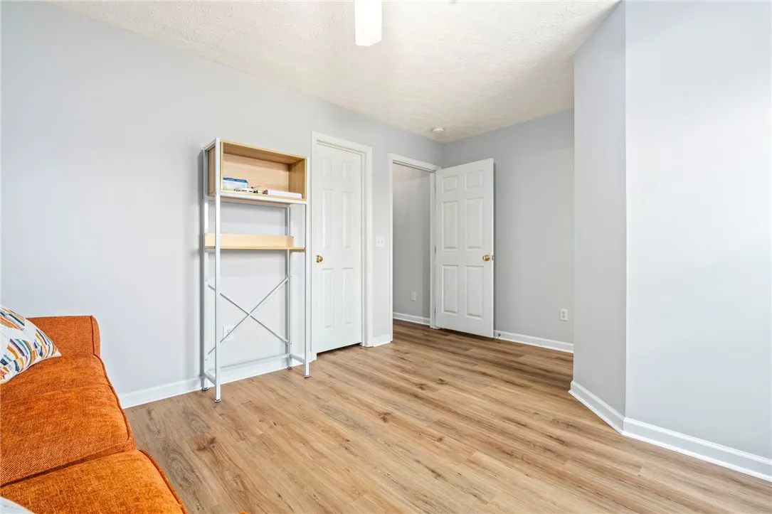 Gleaming wood-look floors complement clean walls in this versatile bonus room.