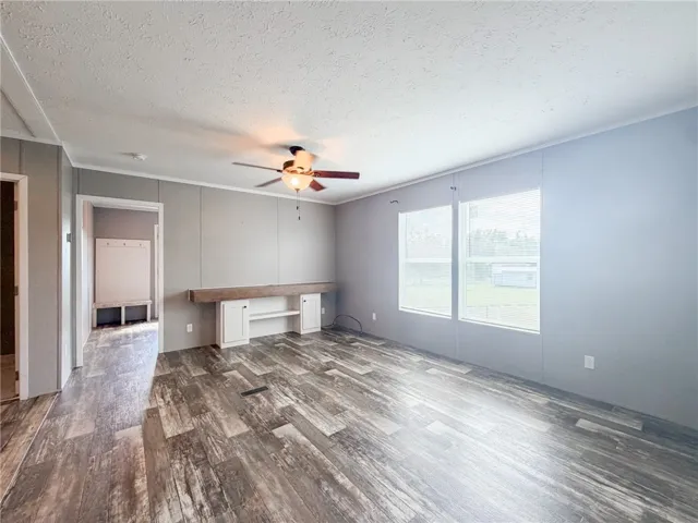 Gleaming wood-look floors pair with clean lines in this versatile living space.