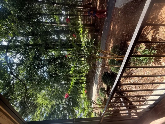Mature trees frame the peaceful outdoor views from this private elevated vantage point.