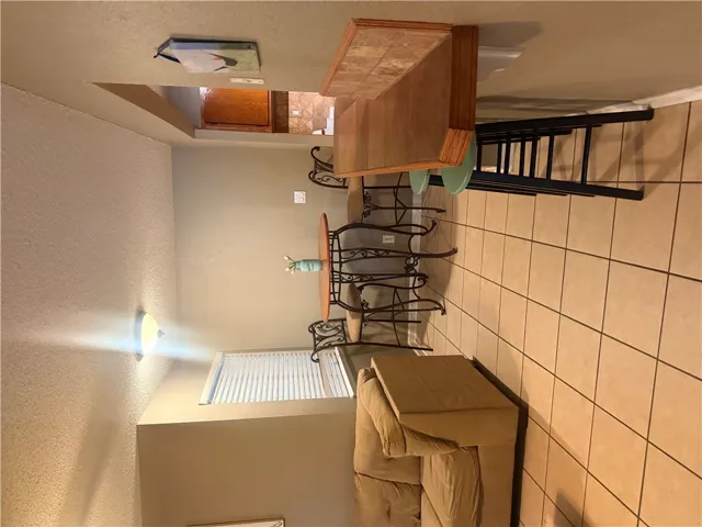 Tiled flooring and a functional breakfast bar define this open dining area layout.