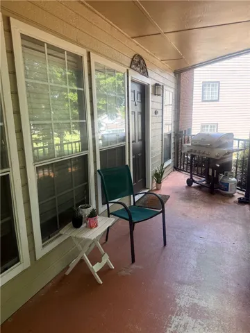 A covered concrete patio offers an inviting outdoor space perfect for relaxation.