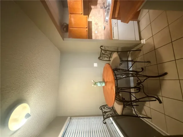 Tiled flooring and a convenient pass-through window connect the dining space directly to the kitchen.