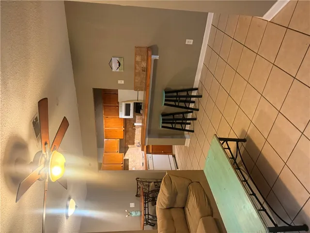 Tile flooring runs throughout this open space connecting the kitchen and living areas.