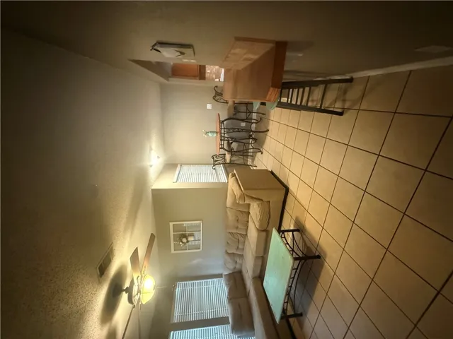 Durable tile flooring anchors this open living space illuminated by natural light.