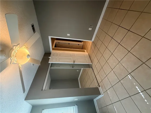 Durable tile flooring runs throughout this versatile space featuring mirrored closet doors.