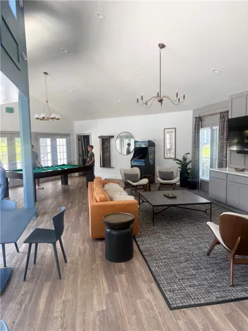 An open and spacious layout showcases wood flooring beneath high vaulted ceilings.