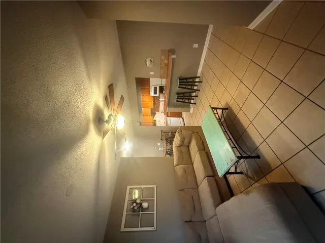 Tiled flooring and a practical breakfast bar connect the main living areas seamlessly.