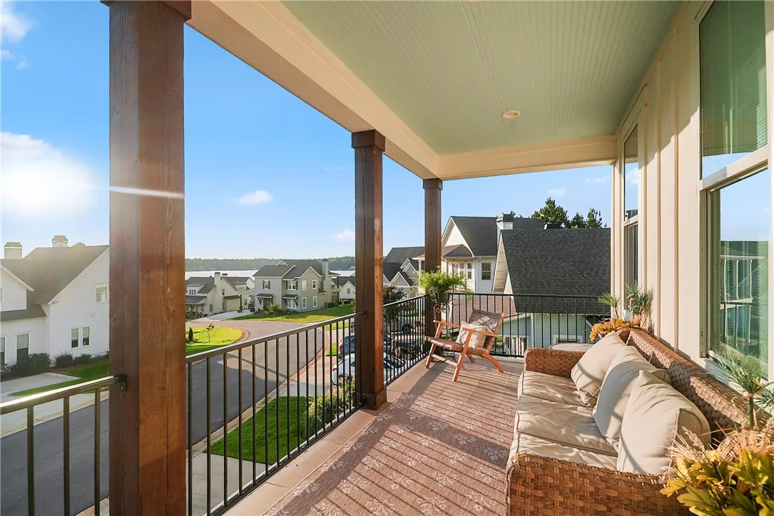 Substantial wood pillars and metal railings frame pleasant neighborhood vistas from this covered porch.