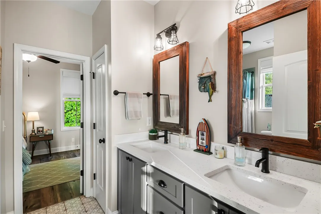 Rich wood frames and dual basins elevate this beautifully finished bathroom vanity area.