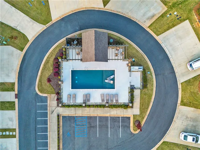 An aerial perspective captures the community pool area nestled within a paved cul-de-sac design.