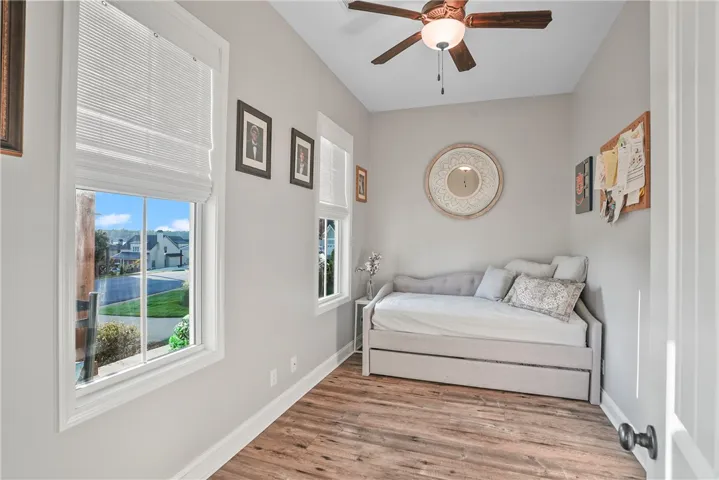 Gleaming hardwood floors and classic window casings define this versatile bedroom space.