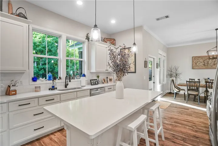 An open floorplan seamlessly connects the well-appointed kitchen to a bright adjoining dining area.
