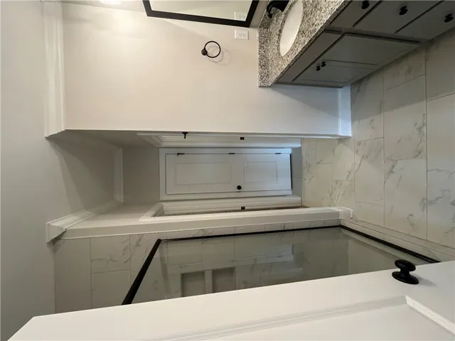 Gleaming stone counters paired with custom tile details define this modern bathroom design.