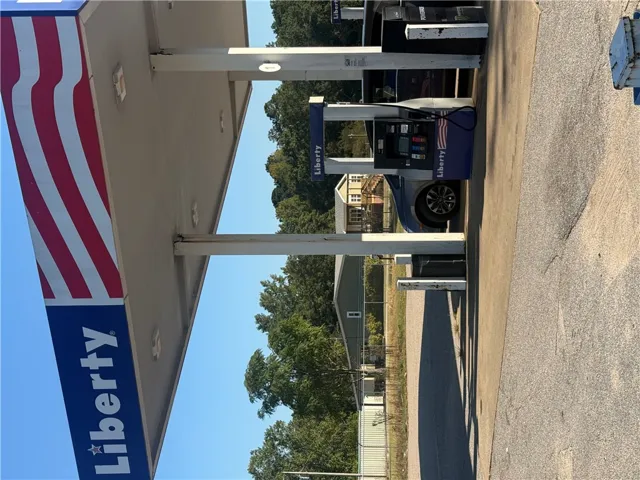 Functional service pumps sit under a metal canopy against a clear sky backdrop.