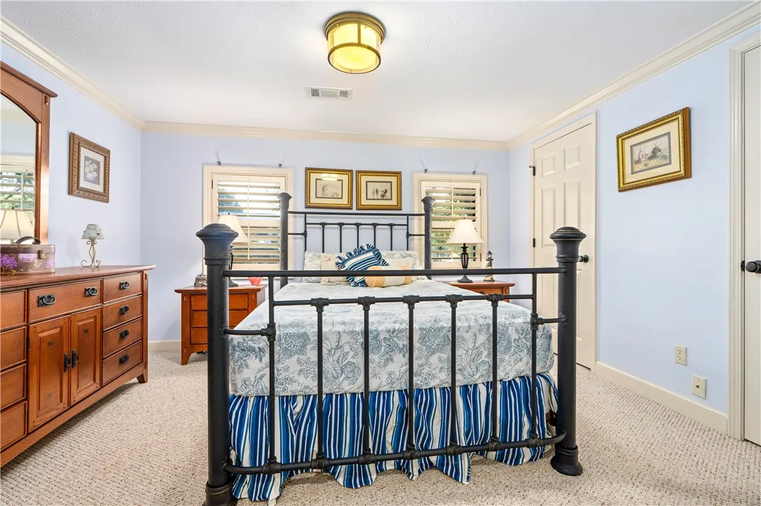 Classic crown molding and soft neutral carpeting define this comfortable private retreat.