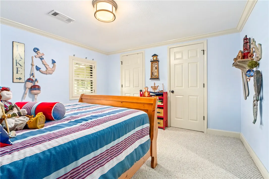 Plentiful natural light filters through classic plantation shutters into this comfortable bedroom.