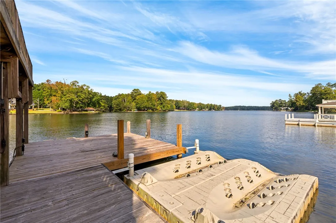 Quiet lakefront living starts on this wooden dock with personal watercraft lifts.