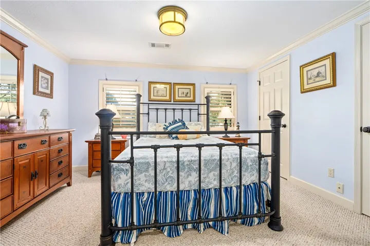 Classic crown molding and soft neutral carpeting define this comfortable private retreat.