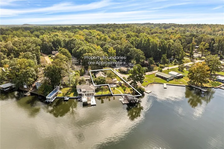 Lush woodland embraces this serene waterfront property directly along the shore.