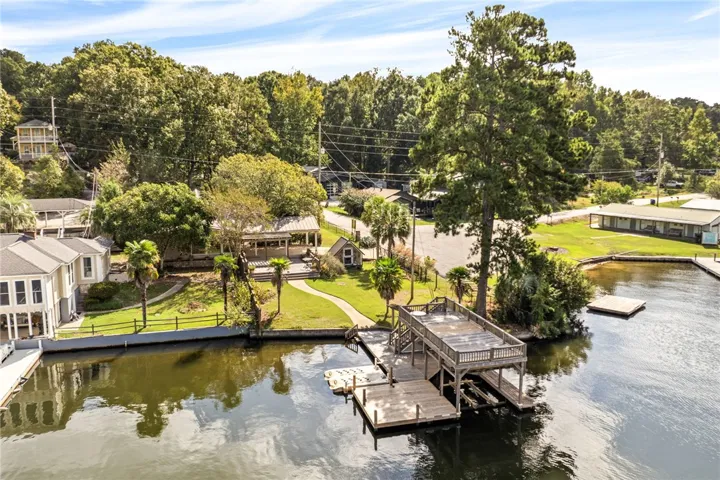 A private multi-level dock overlooks the tranquil water in this serene lakeside setting.