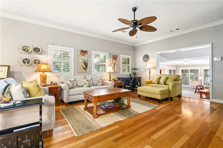 Gleaming hardwood floors and classic crown molding anchor this open, airy living space.