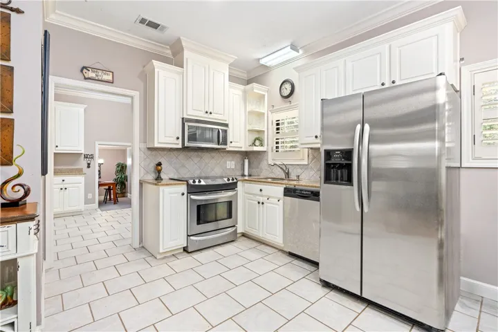 White cabinetry and tile flooring define this well-appointed kitchen.