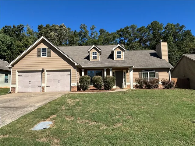 Traditional architectural details define this charming home situated against a mature wooded backdrop.