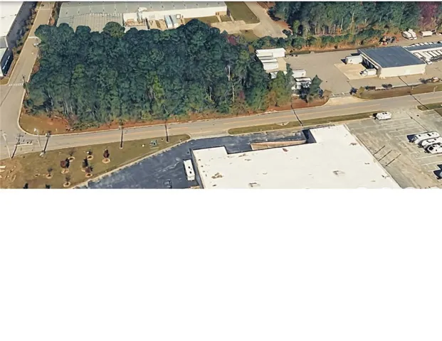Mature woodlands line this versatile commercial corridor ready for development.
