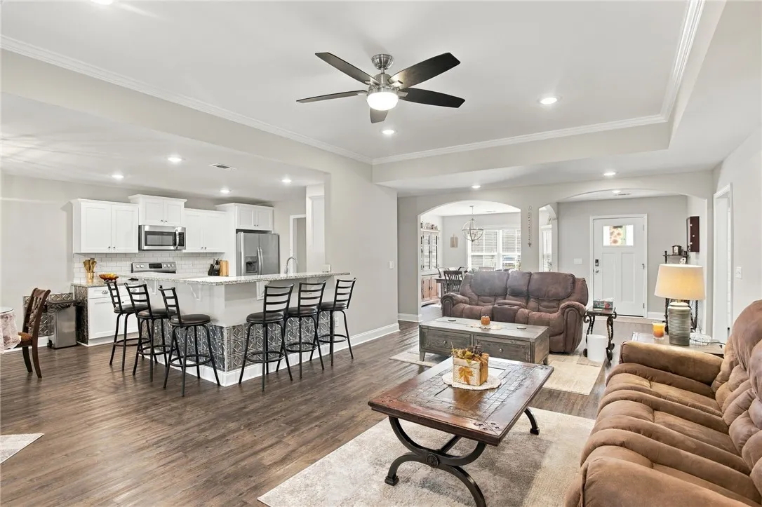 Rich LVP flooring anchors this open layout connecting the main living area and kitchen.