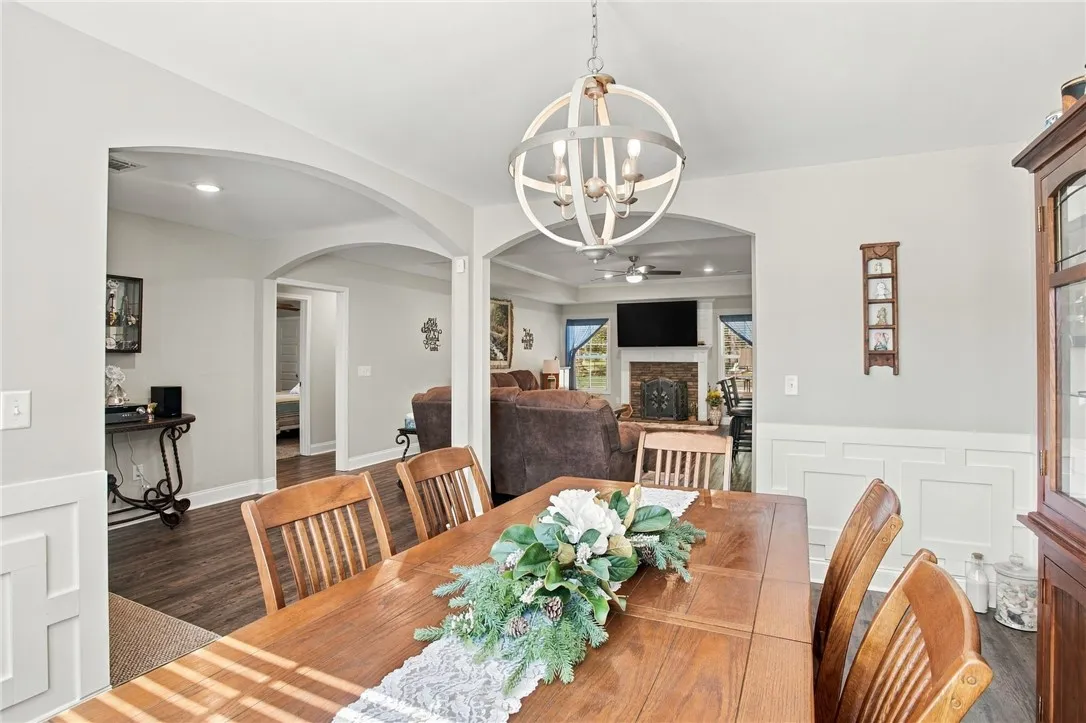 Arched doorways connect this refined dining space to the open living areas beyond.
