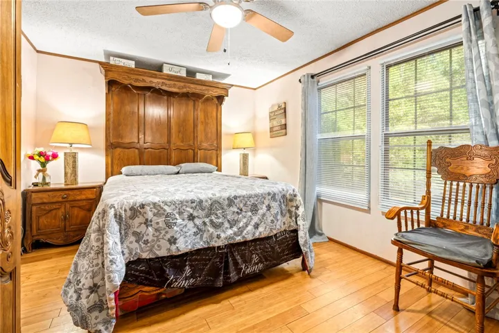Rich hardwood flooring anchors this light-filled space featuring large dual windows.