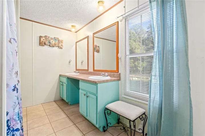 Double vanities and classic tile flooring define this functional master bath layout.