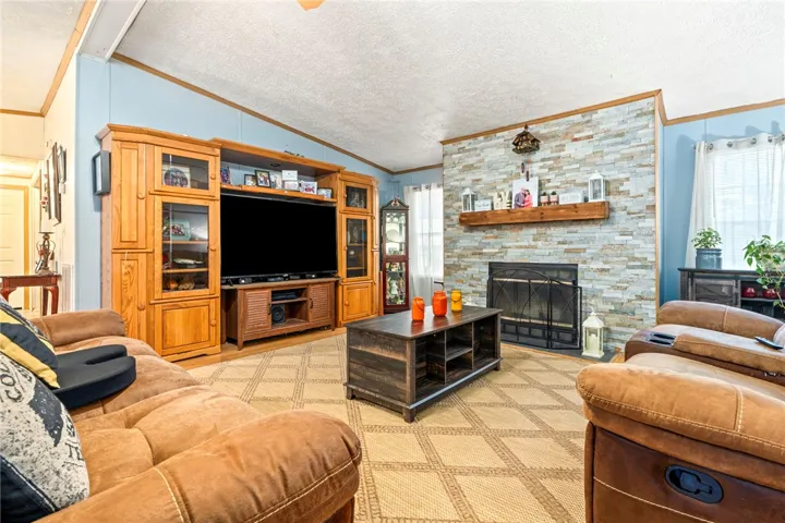 An impressive floor-to-ceiling stone fireplace serves as the centerpiece of this inviting living room.