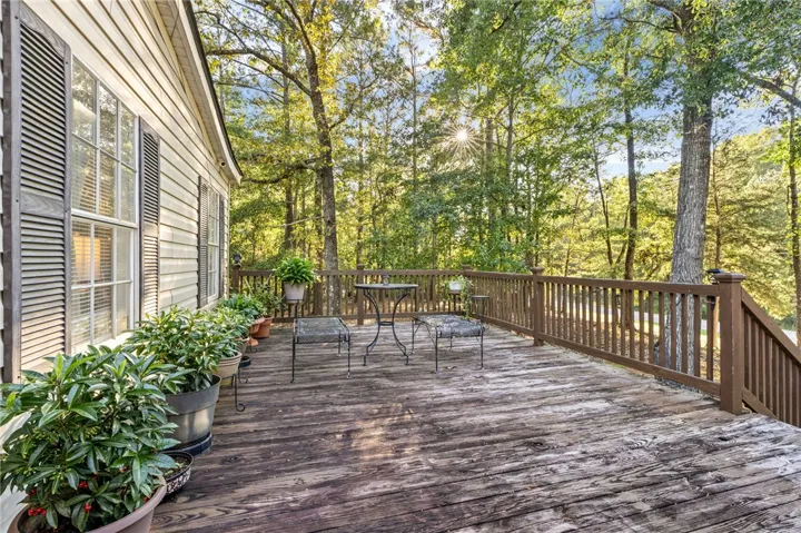 Mature woodlands provide a peaceful backdrop for the spacious wooden deck.