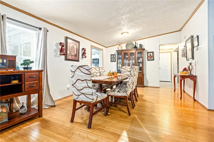 Laminate flooring and crown molding define this open dining area.