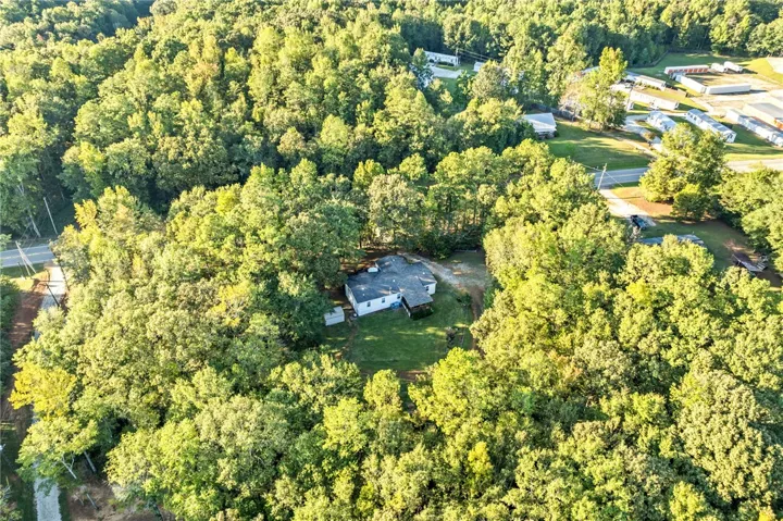 Mature trees surround this peaceful property, offering exceptional privacy and a serene natural setting.
