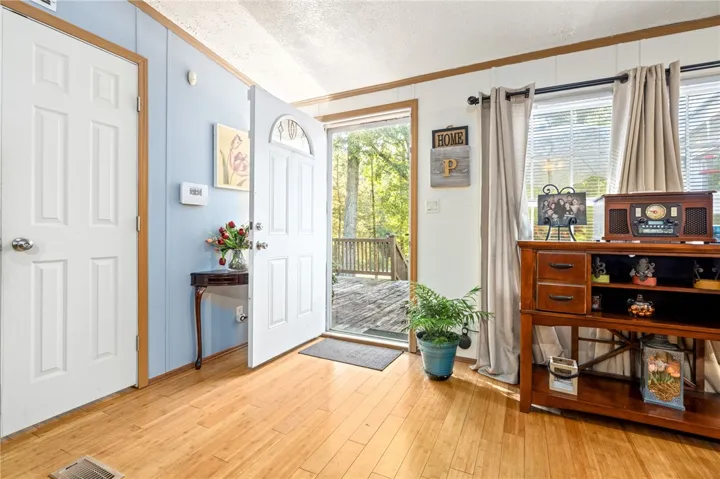 Warm wood floors and a light-filled entry create an immediate sense of welcome.
