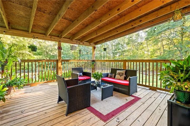 A spacious covered deck overlooks peaceful, wooded backyard views.