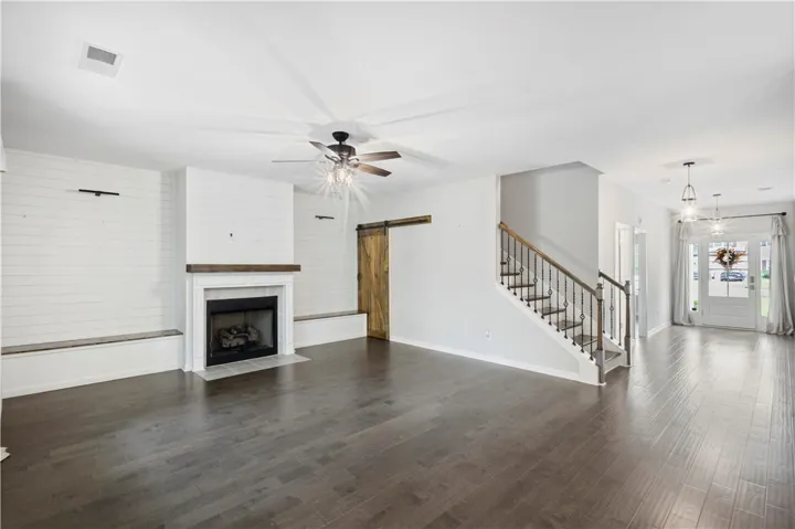 Rich dark wood floors and a classic fireplace anchor this versatile open main level.