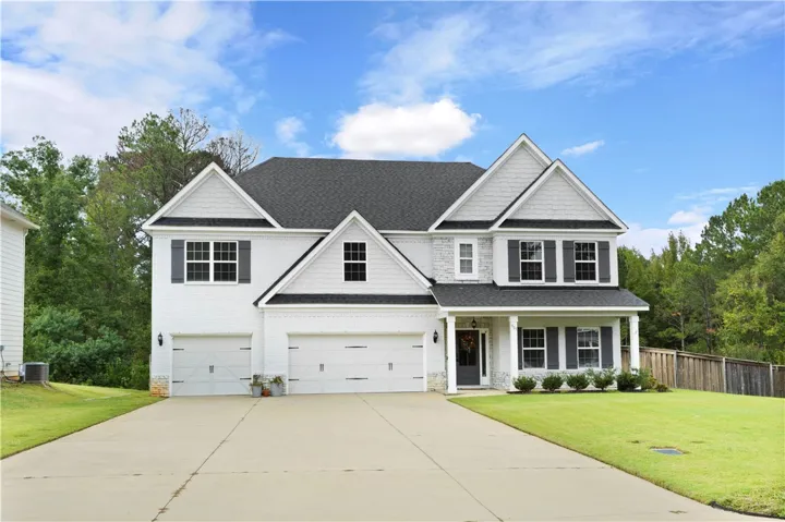 Gable roofs and classic shutters define this elegant multi-car garage residence.