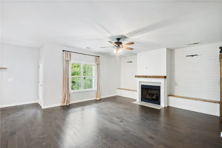Gleaming hardwood floors and a modern fireplace anchor this open and airy living space.