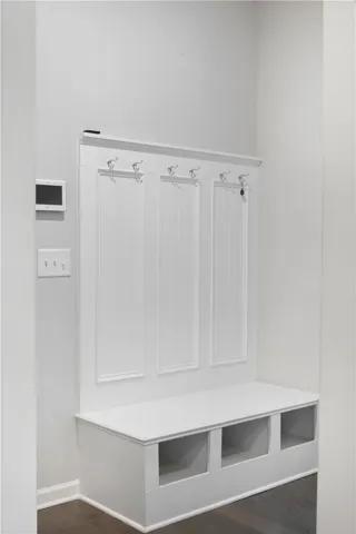 A built-in drop zone with storage cubbies and coat hooks anchors this entry space.