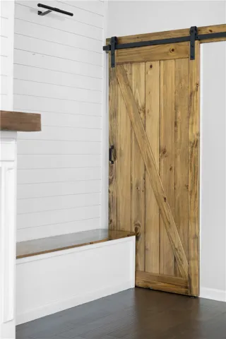 Rich wood tones and clean shiplap accents create a welcoming entryway design.