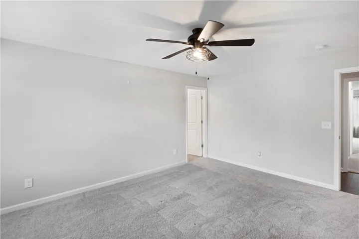 Plush wall-to-wall carpeting and neutral tones define this versatile interior room.