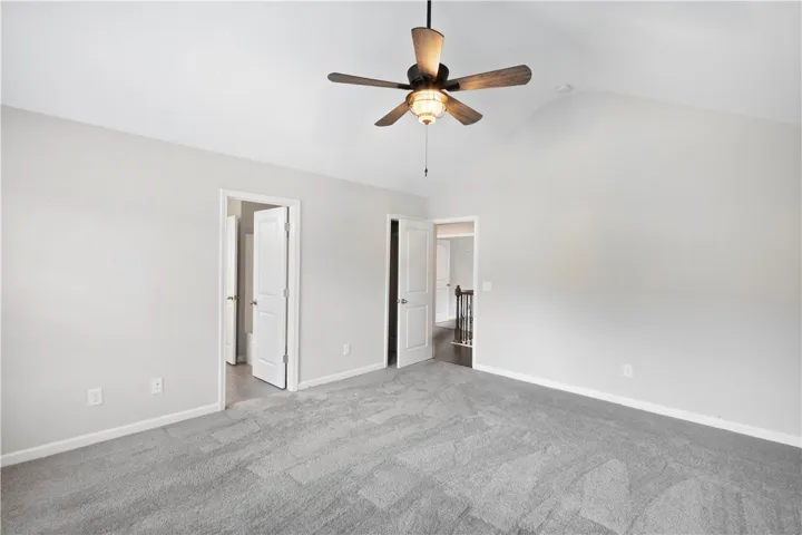 Plush carpeting and vaulted ceilings define this peaceful primary suite.