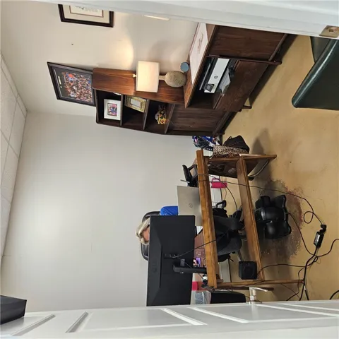 Quiet office space features neutral walls and wall-to-wall carpeting.
