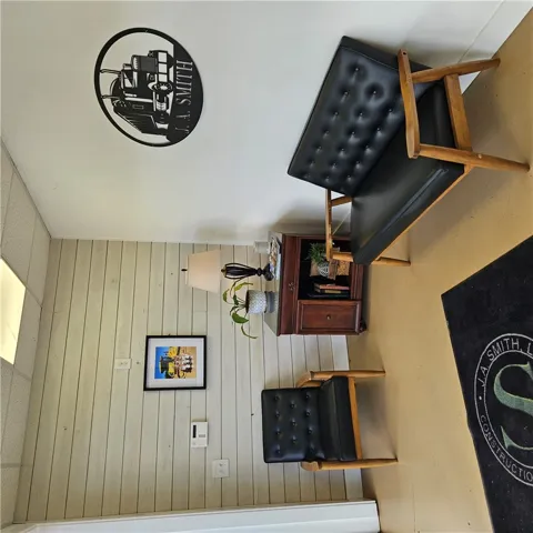 Smooth concrete flooring pairs beautifully with classic wood paneled walls in this welcoming entry space.